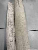 Rug rolled showing backing and pattern