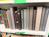 Front view of all 16 neutral coloured books on shelf