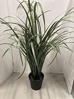 Full view of artificial onion grass plant in pot