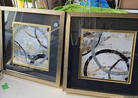 Both framed prints side by side