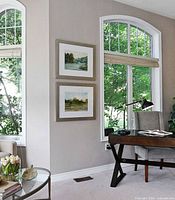 Both framed artworks hung on wall showing scale and matching frames