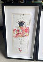 Framed print showing front-facing fashion figure with pink floral skirt