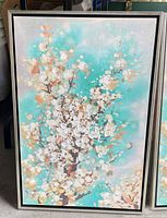 Framed canvas print with turquoise background and white blossoms