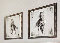 Both framed horse artworks hanging side by side