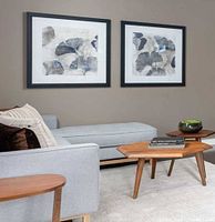 Both framed prints hung side by side in a room setting