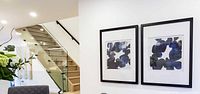 Both framed prints displayed side by side on wall