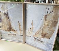 Both framed sailboat prints side by side