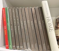 Spine view of all 13 Pottery Barn hardcovers lined on shelf
