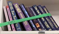 Shelf showing the ten purple-spine books in a row