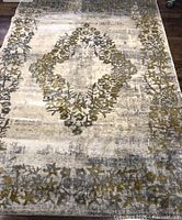 Full view of rug showing color and medallion pattern