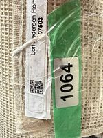 Rolled rug with label and lot sticker visible