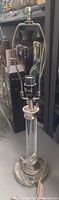 Full view of lamp base, harp and finial