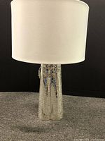 Lamp fully assembled showing silver crackle base and white drum shade