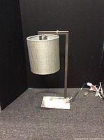 Full view of lamp showing offset frame and shade