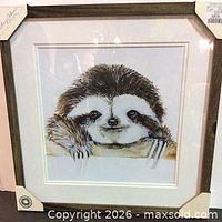 Front view of framed sloth artwork showing full image, matting and frame