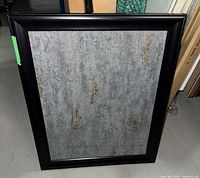 Front view of framed silver and copper textured artwork