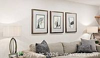 Three framed abstract artworks above sofa showing size and matching frames
