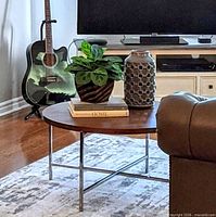 Coffee table in living room setting showing walnut top and chrome legs