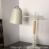 Full view of white desk lamp front profile
