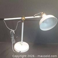 Overall view of white desk lamp with adjustable arm and shade