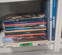 Front view of stacked and upright books showing titles and quantity