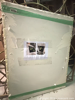 Back of one print with green tape edging and attached reference sheet