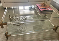 Full view of rectangular acrylic and glass coffee table in living room setting
