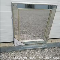 Front view of entire mirror leaning against wall