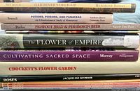 Stack of seven visible horticulture books with spines showing titles and authors
