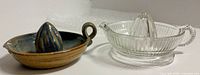 Clear glass juicer and handmade ceramic juicer side by side