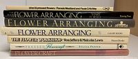 Spine view of all seven flower crafting books stacked