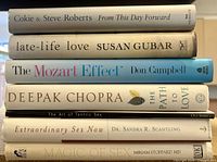 Stacked spines of all seven hardcover books listed