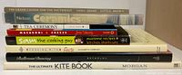 Stack of eight hobby and activity themed books showing all titles on spines