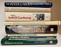 Stack of nine gardening books showing titles on spines