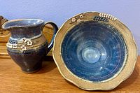 Blue ceramic pitcher and bowl showing glaze color and decorative motifs