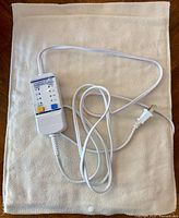 Full view of heating pad with attached controller and power cord
