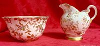 Creamer jug and sugar bowl showing floral design and gold trim