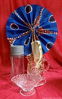 Plastic water bottle, glass gravy boat, pressed glass pitcher with bone comb, hand-printed fabric fan