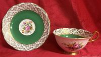 Teacup and saucer showing full design, colors and condition