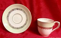 Teacup and saucer showing color and gold detailing
