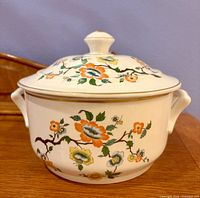 Covered casserole front view with lid showing floral pattern and handles