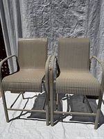 Full front view of both beige bar-height chairs