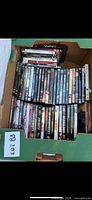 Top view of box showing two packed rows of DVD spines, lot ID card visible