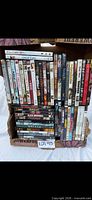 Full box of assorted DVDs, front view showing quantity