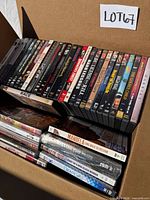 Open box showing two rows of DVD spines with titles visible