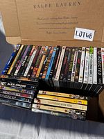 Open Ralph Lauren box showing two rows of DVD spines plus extra stack outside box