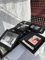 Stack of black photo frames showing various sizes and matting