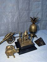 Group shot showing pineapple, cannon, Taj Mahal, pyramid, elephants