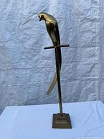 Front view of brass parrot on stand showing overall design and height