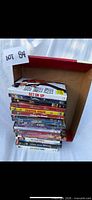Full stack of DVD cases in open cardboard box